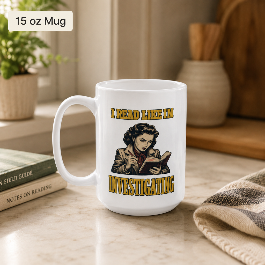 White 15 oz I Read Like I’m Investigating mug on a bright table beside two closed books and a folded blanket.