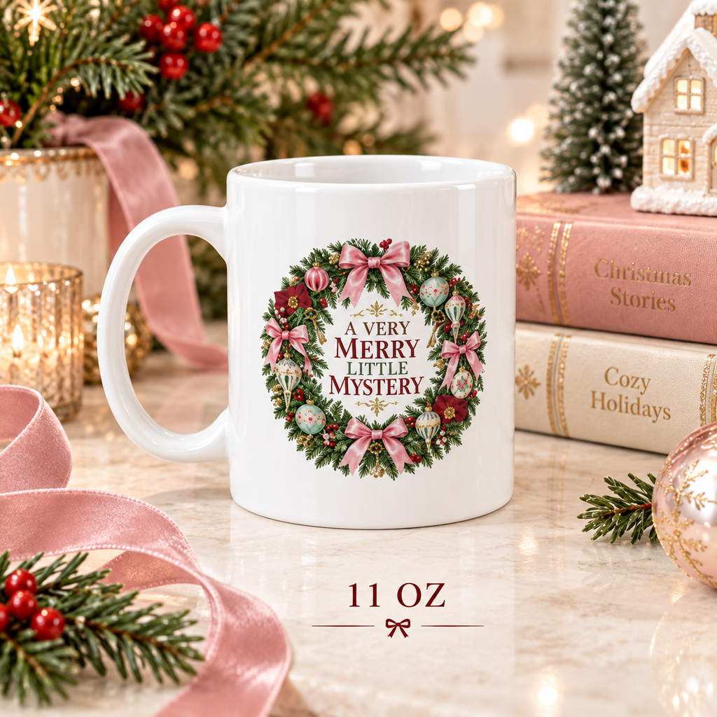 11-ounce “A Very Merry Little Mystery” mug styled with pink satin ribbon, evergreen branches, red berries, glowing candles and Christmas storybooks.