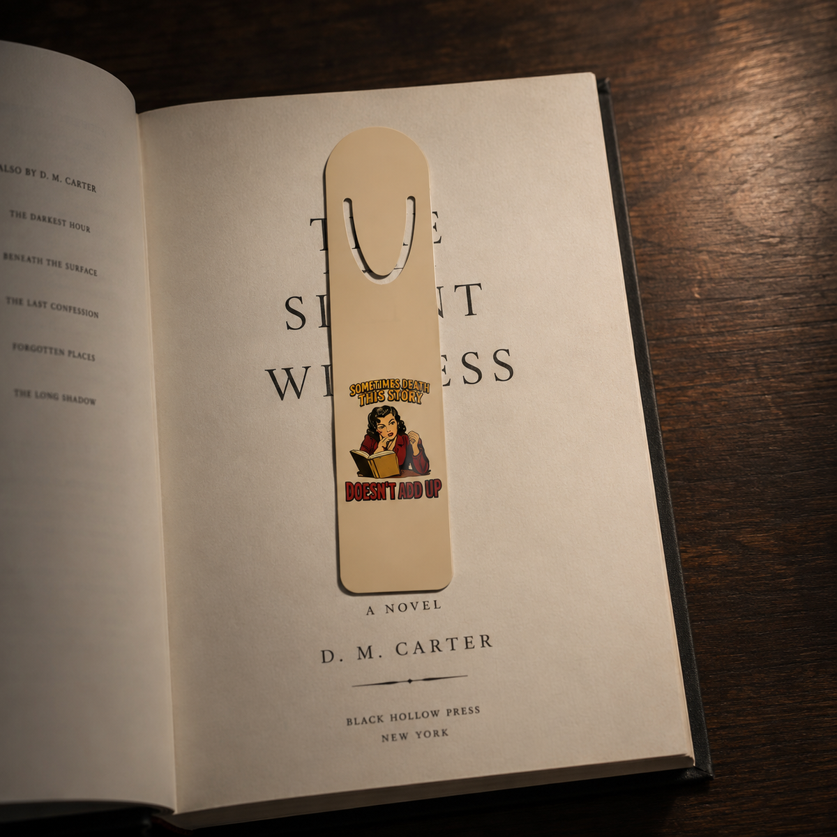 Something About This Story Doesn’t Add Up aluminum bookmark clipped over the title page of an open mystery novel.