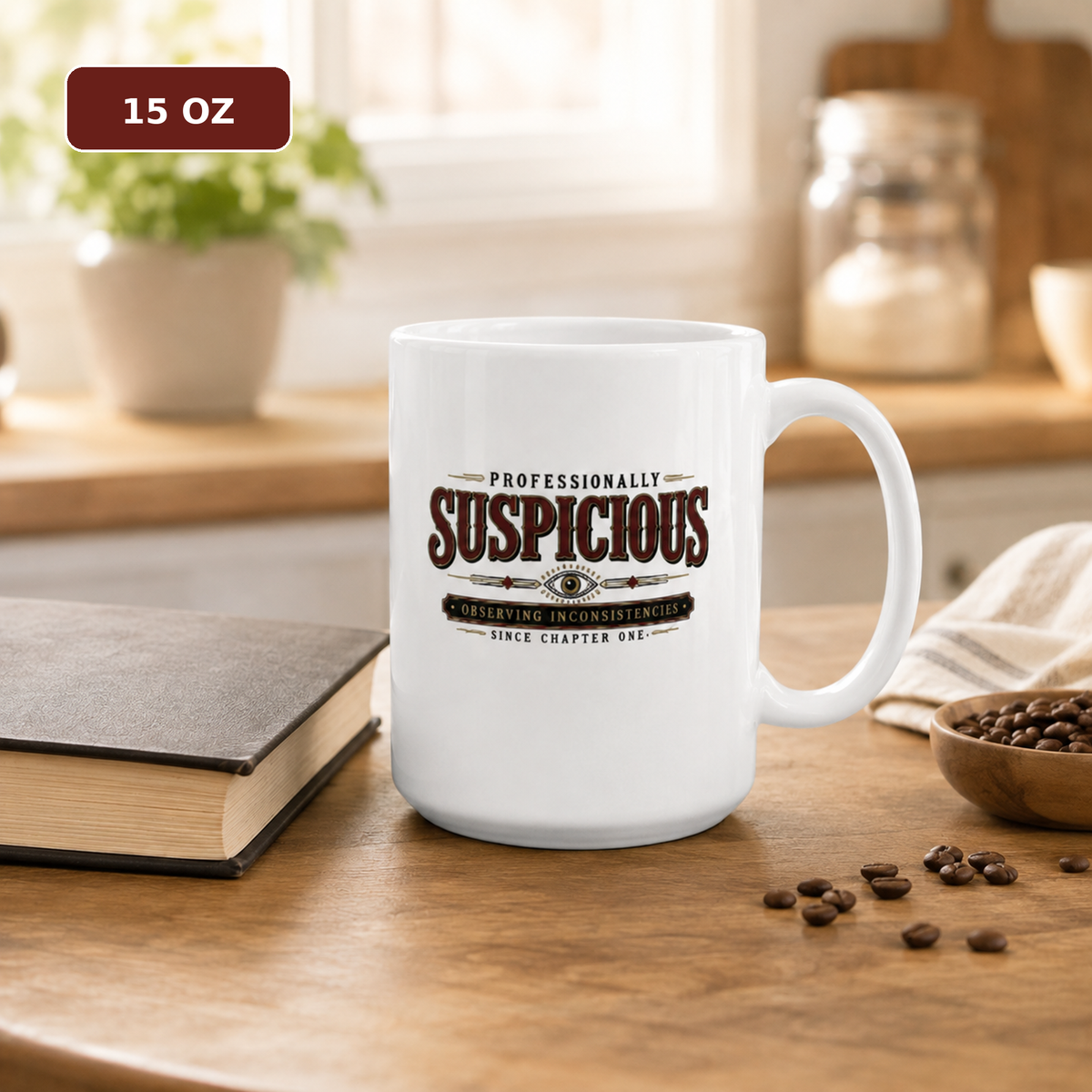 15 oz “Professionally Suspicious” mug on a kitchen table beside a closed book and scattered coffee beans.
