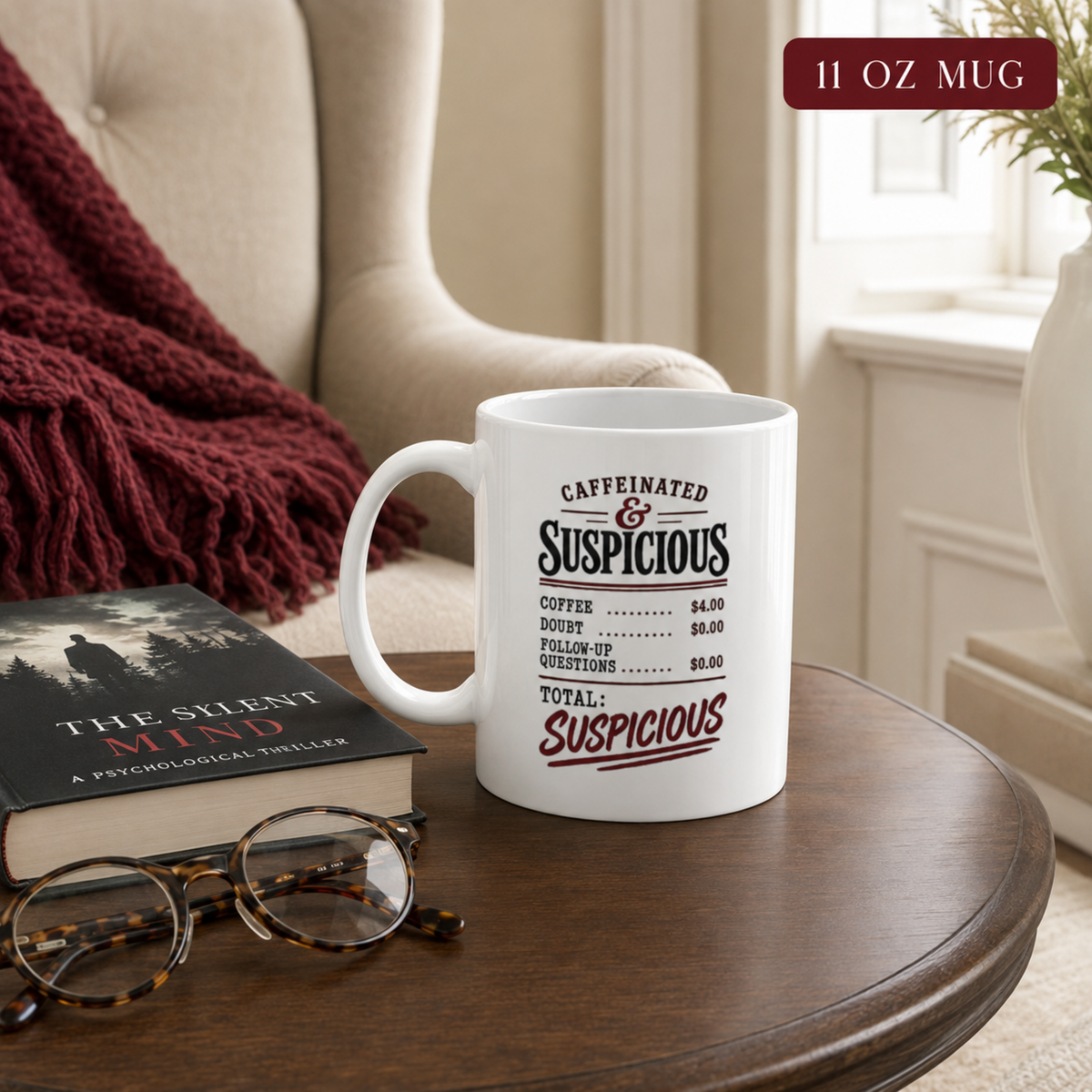 11 oz “Caffeinated & Suspicious” receipt-style mug on a round table beside a psychological thriller novel and reading glasses.