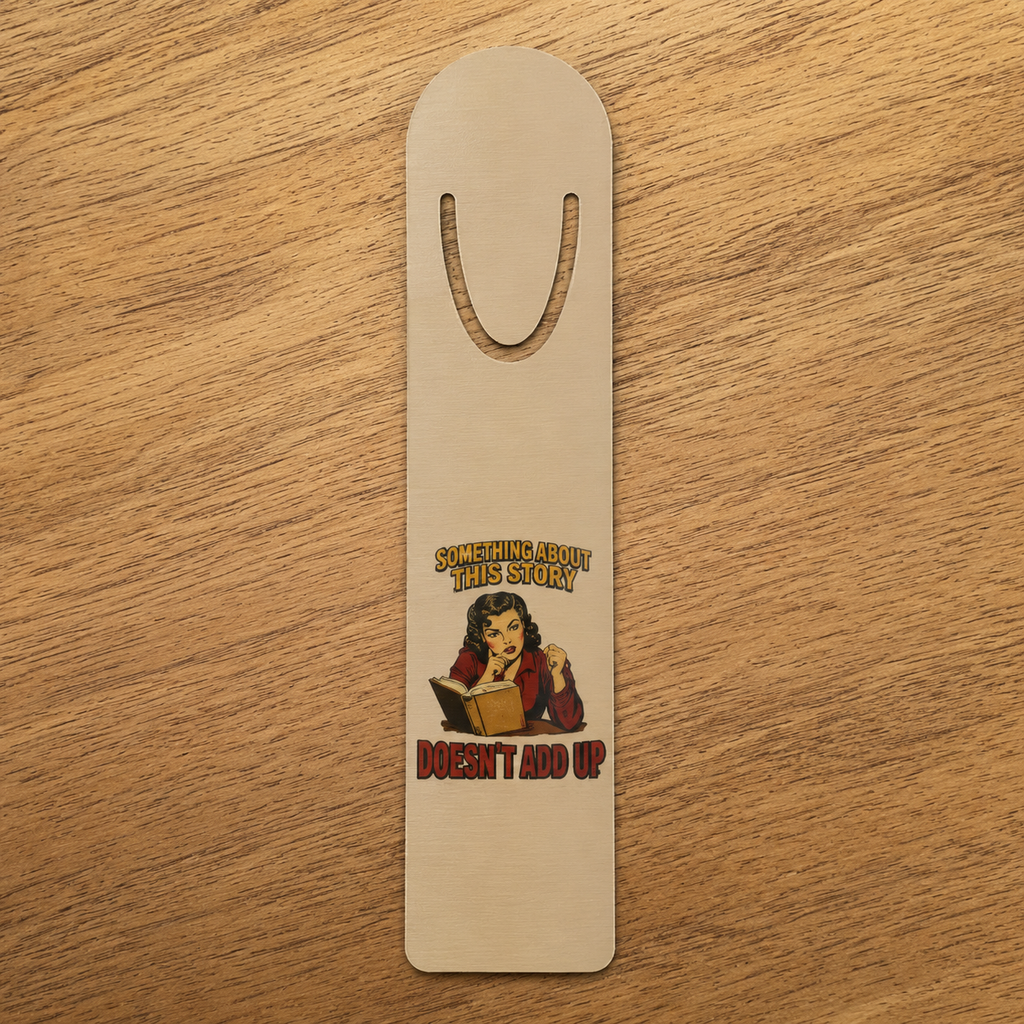 Full view of the Something About This Story Doesn’t Add Up aluminum bookmark on a light wood surface.