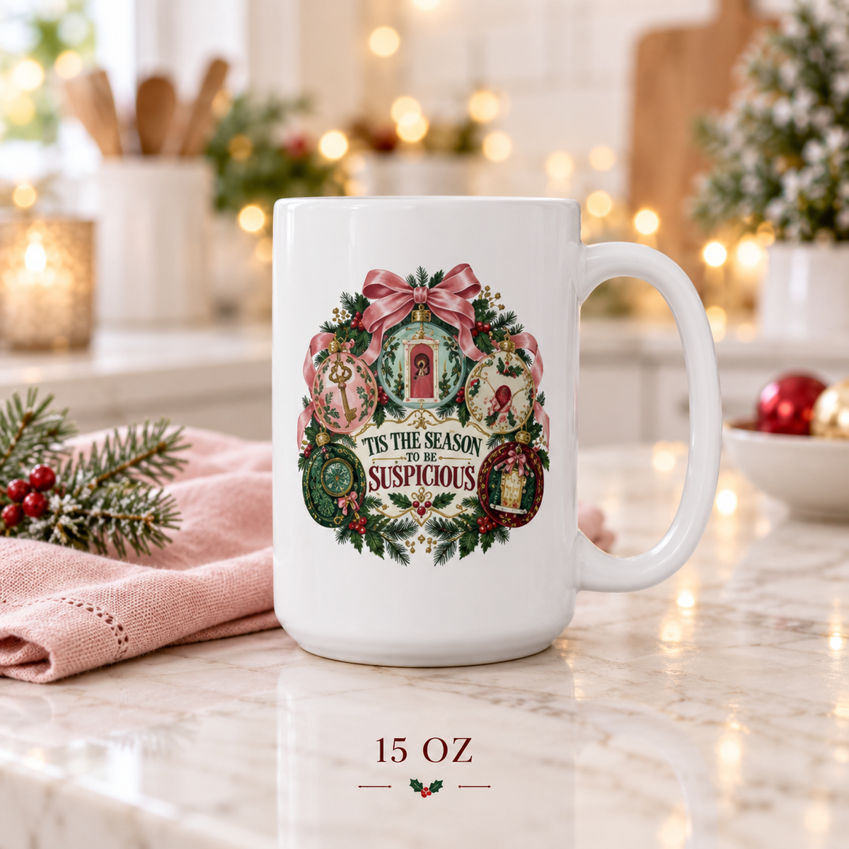 15-ounce “’Tis the Season to Be Suspicious” mug displayed on pale marble with pink knit fabric, evergreen branches, red berries and warm kitchen lights.