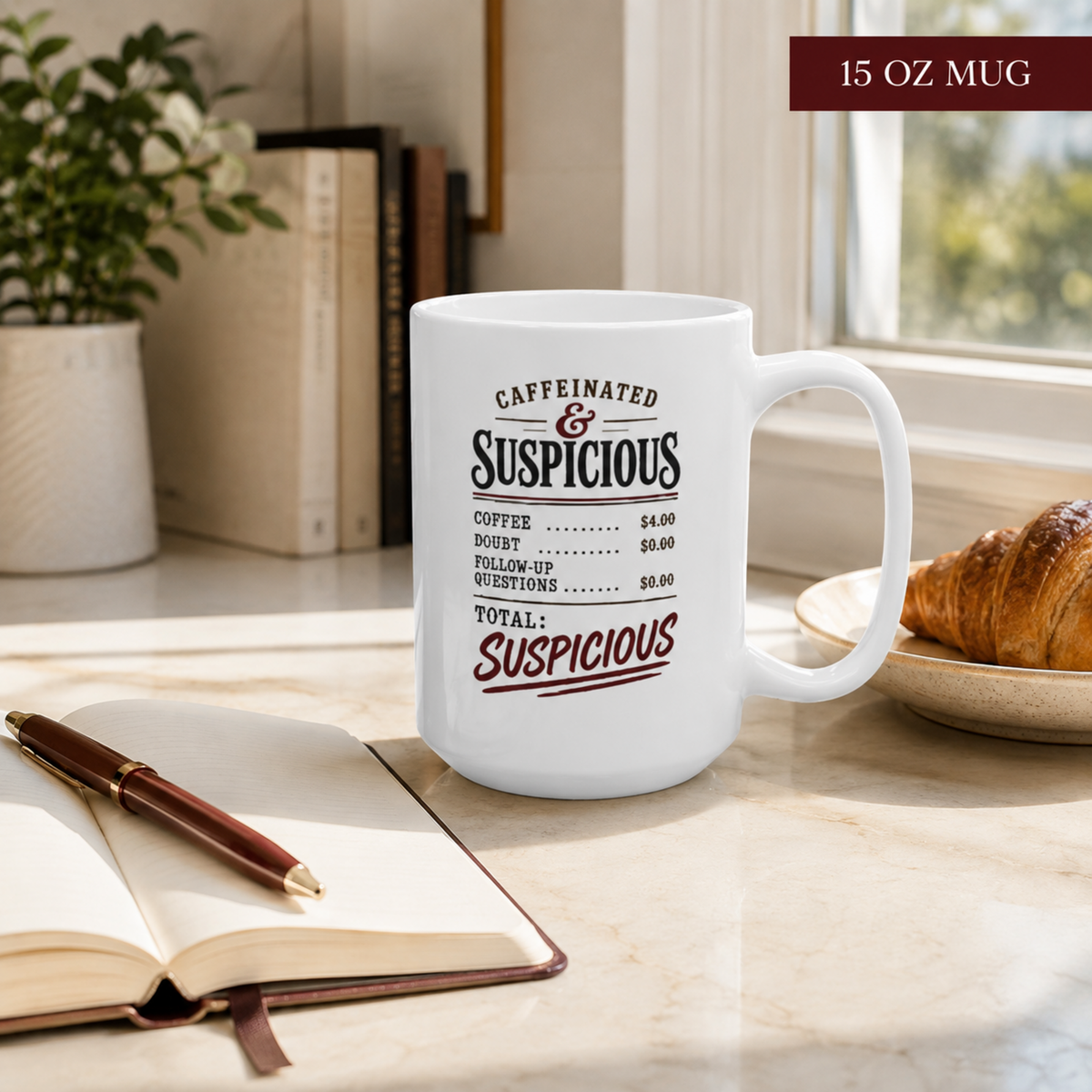 15 oz “Caffeinated & Suspicious” mug on a bright kitchen table beside an open notebook, pen, books, and a croissant.