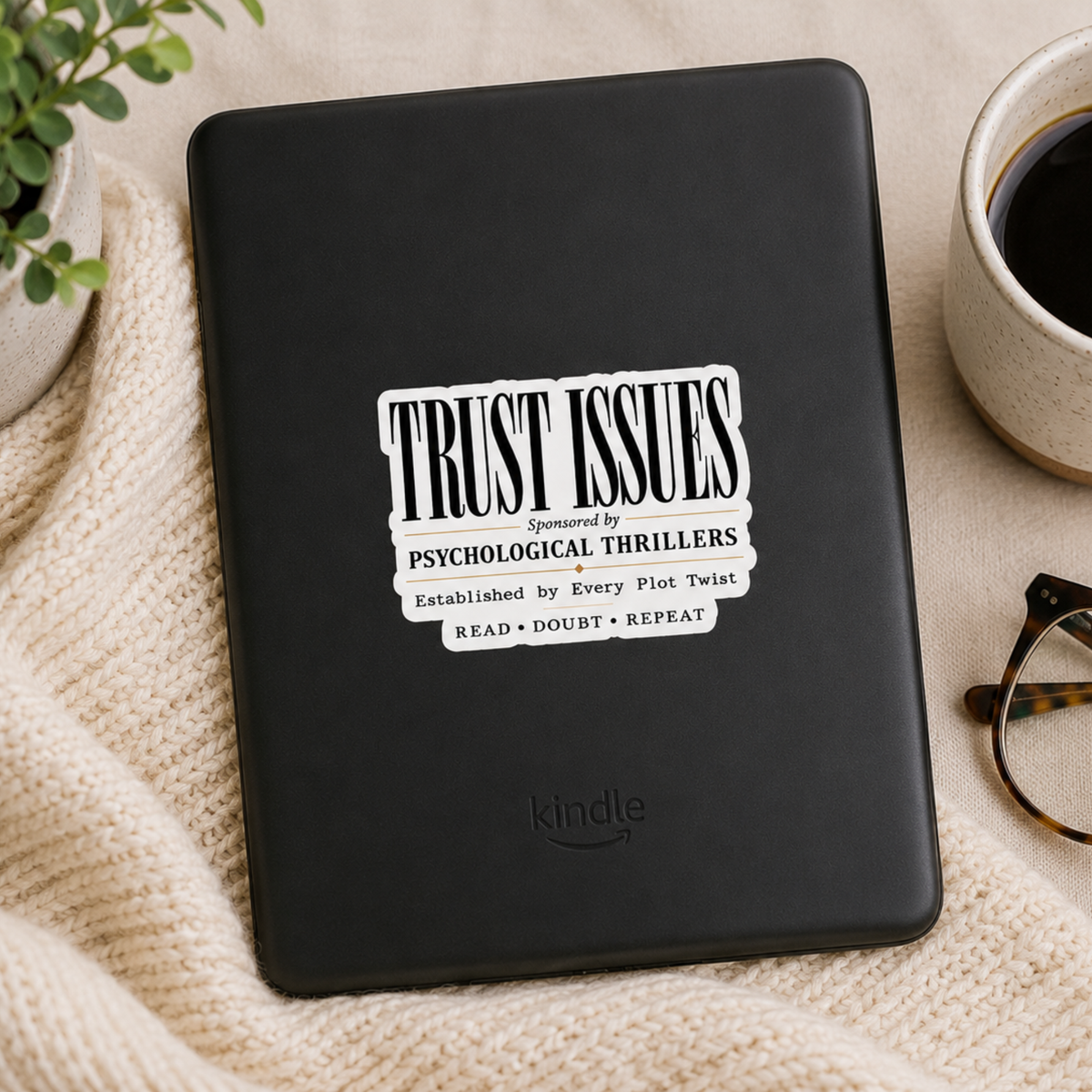 “Trust Issues. Sponsored by Psychological Thrillers. Established by Every Plot Twist. Read • Doubt • Repeat” sticker with black typography, shown on a black Kindle.