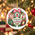 “’Tis the Season to Be Suspicious” ceramic ornament featuring vintage baubles with a key, red door, magnifying glass and sealed letter, hanging on a glowing Christmas tree.