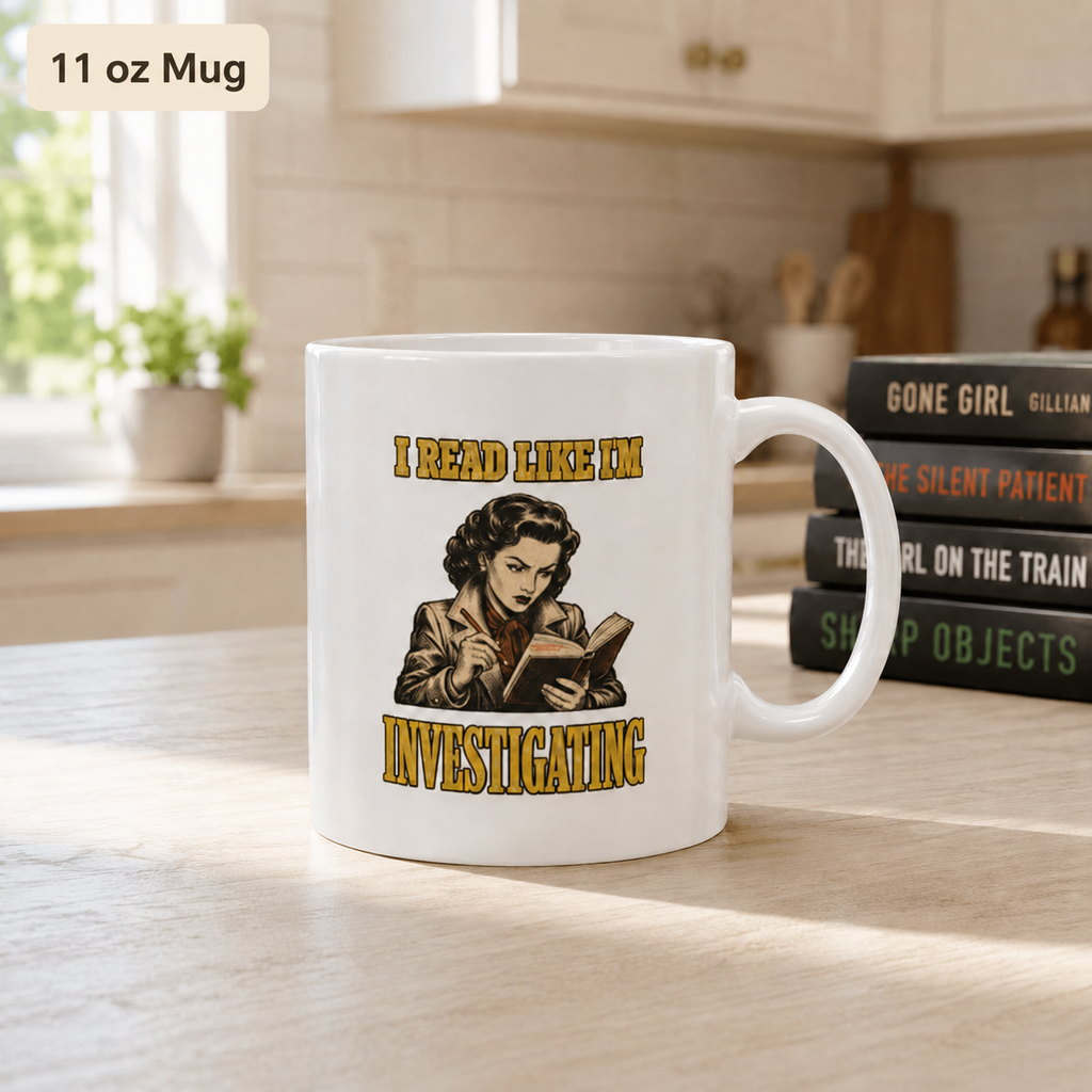 White 11 oz mug on a kitchen table with vintage illustration of a reader and the words “I Read Like I’m Investigating”; thriller books stand behind it.