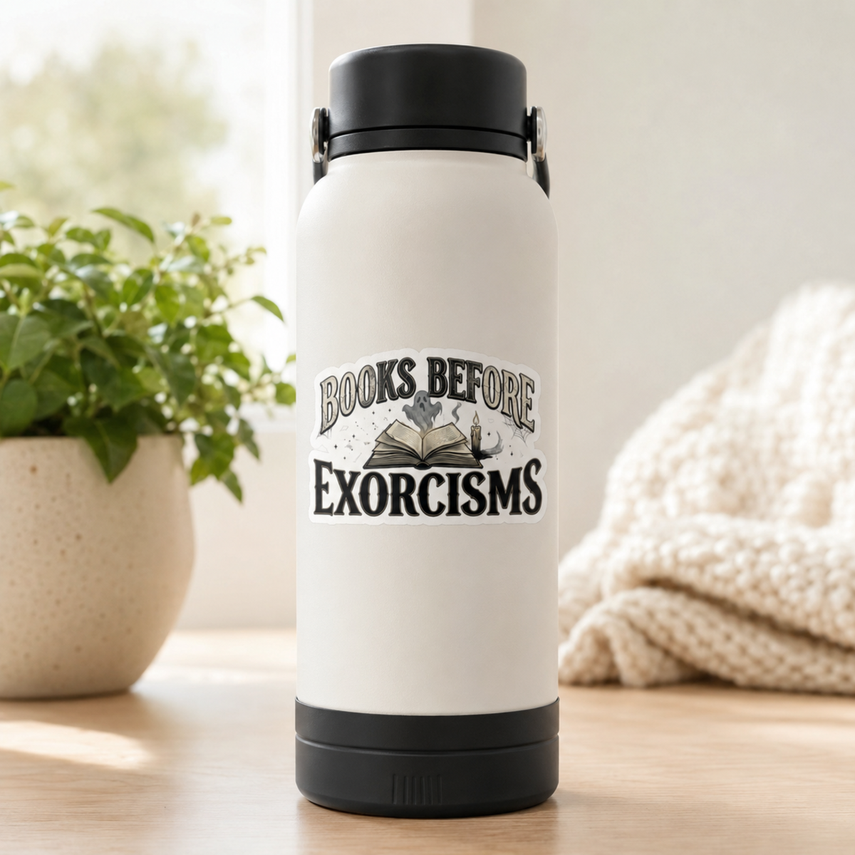 “Books Before Exorcisms” sticker with black lettering, an open book, gray ghost, candle, and cobweb, shown on a white water bottle.