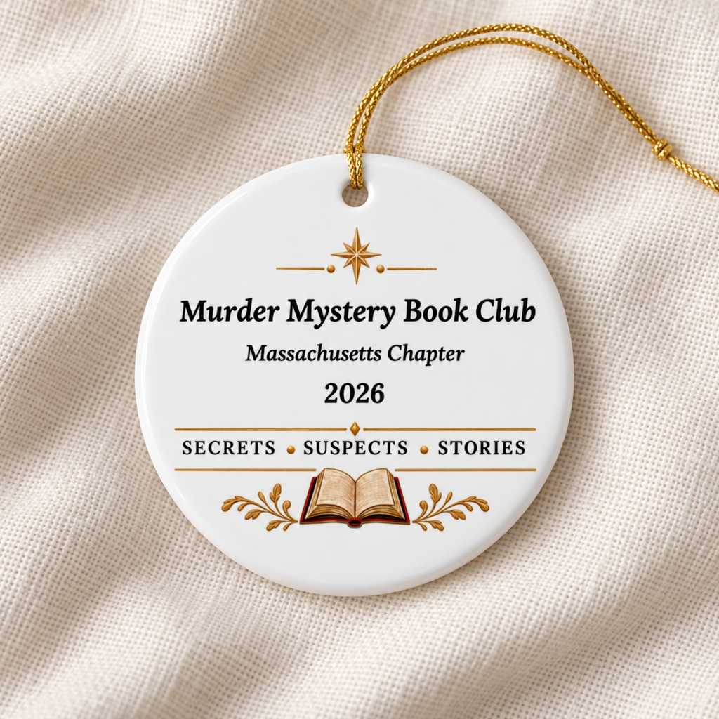 Close-up of a white round ornament on cream fabric, with gold string, star and open book; reads “Murder Mystery Book Club,” “Massachusetts Chapter,” “2026” and “Secrets • Suspects • Stories.”